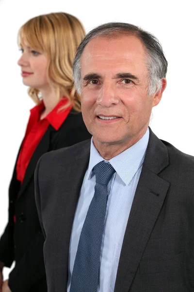 Senior businessman and his young assistant posing — Stock Photo, Image