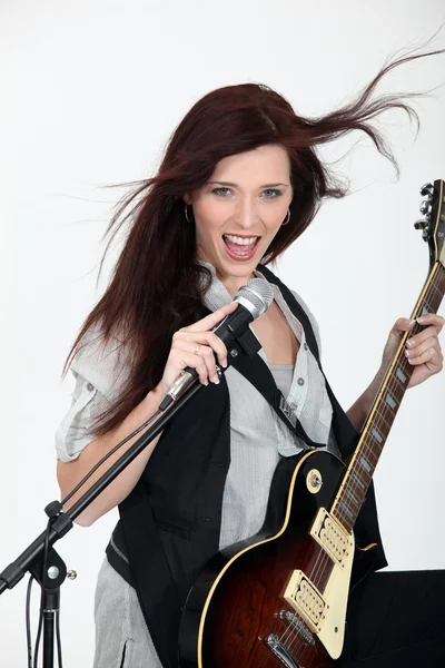 Girl playing guitar and singing — Stock Photo, Image