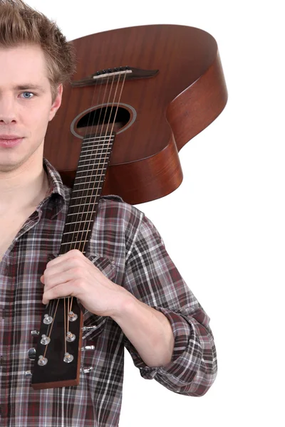 Young man with an acoustic guitar — Stock Photo, Image