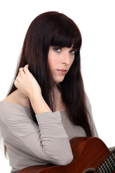 Brunette woman with guitar Royalty Free Stock Images