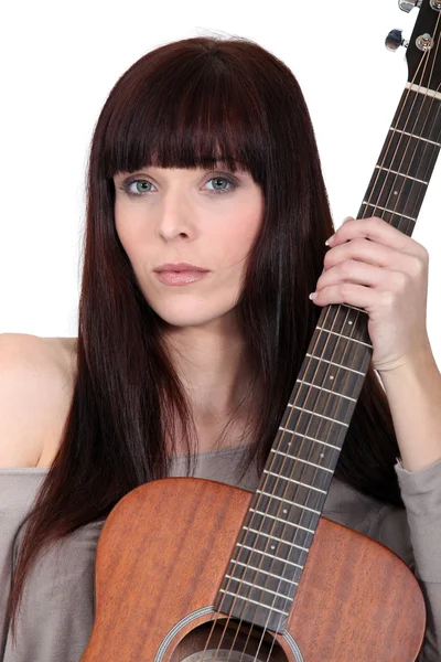 Busker posing with her guitar Royalty Free Stock Images