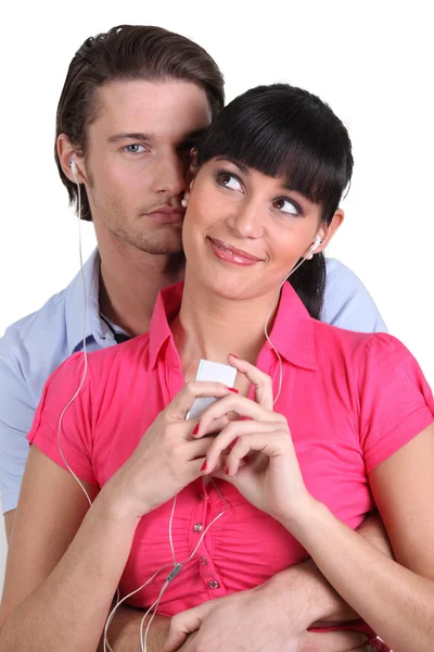 Couple sharing headphones audio — Stock Photo, Image