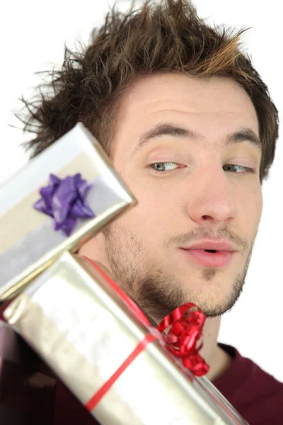 Man with a pile of gifts — Stock Photo, Image