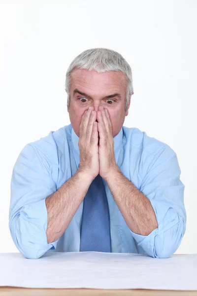 Geschokt man kijken naar een blauwdruk — Stockfoto