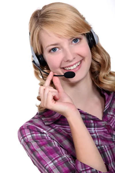 A blond woman with a headset on. — Stock Photo, Image