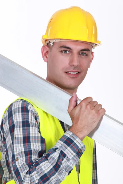 Construction worker carrying metal — Stock Photo, Image