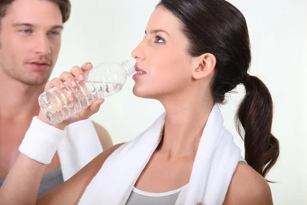 Vrouw die water drinkt na een training — Stockfoto