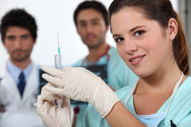 Nurse holding needle clipart