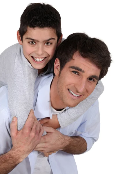 Father giving young son piggyback — Stock Photo, Image