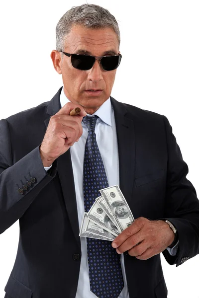 Businessman with cigar and money — Stock Photo, Image