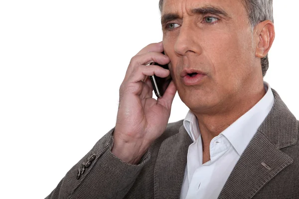 Mature man at phone having trouble — Stock Photo, Image