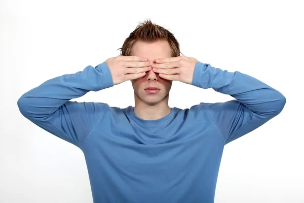 Young man covering his eyes — Stock Photo, Image