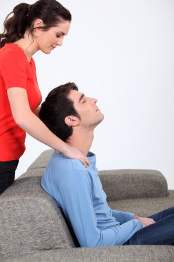 Woman giving husband back massage clipart