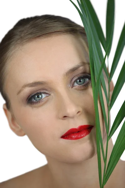 Woman stood holding plant leaf — Stock Photo, Image