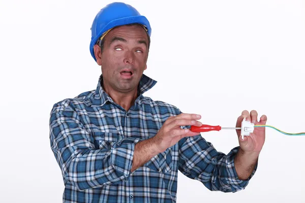 Tradesman suffering from electric shock — Stock Photo, Image