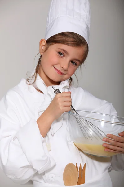 Retrato de una niña con ropa de panadero — Foto de Stock