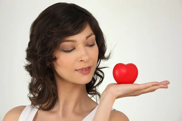 Young woman holding a plastic hearth in her hand — Stock Photo, Image