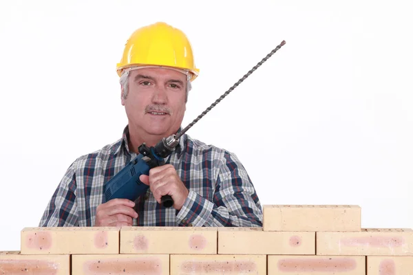 Senior mason holding brick drill — Stock Photo, Image