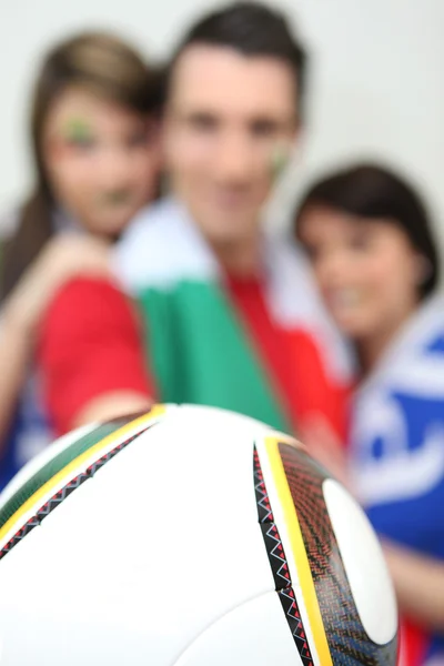 Football fans holding a ball — Stock Photo, Image