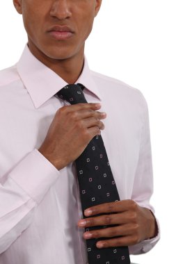 Businessman straightening his tie clipart