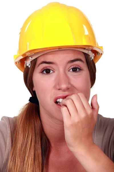 Mulher com capacete mordendo as unhas — Fotografia de Stock