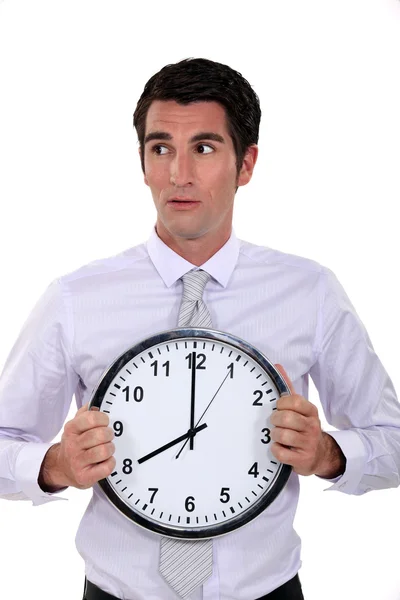 Businessman holding large clock — Stock Photo, Image