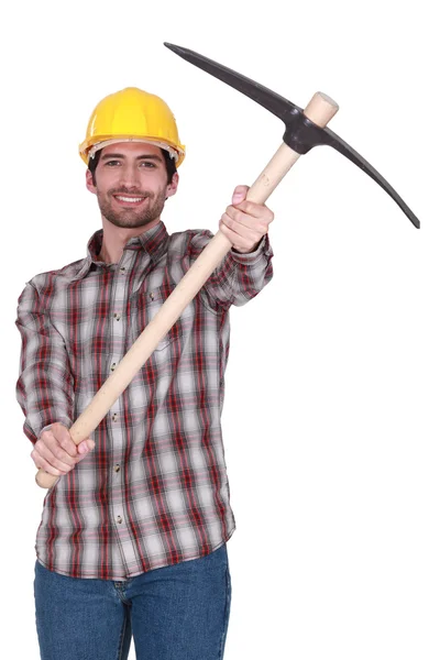 Tradesman holding up a pickaxe — Stock Photo, Image