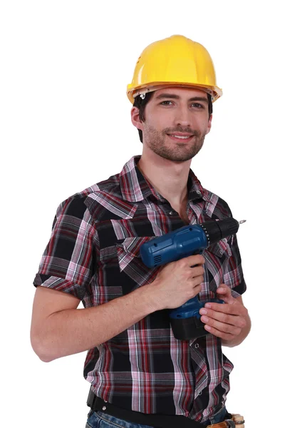 Junger Handwerker mit einer Bohrmaschine — Stockfoto