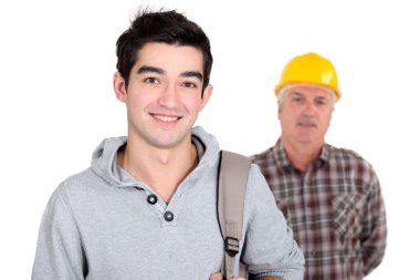 Young man standing next to an experienced worker clipart