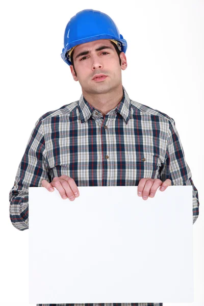 Builder holding poster — Stock Photo, Image