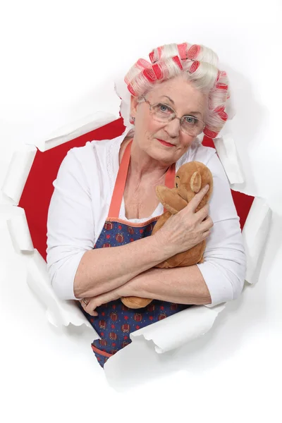 Elderly woman holding teddy — Stock Photo, Image