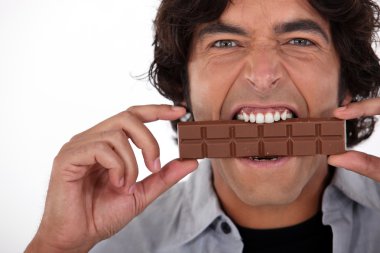 Man playfully eating chocolate clipart