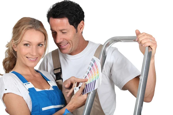 Decorating couple with color chart and steps — Stock Photo, Image