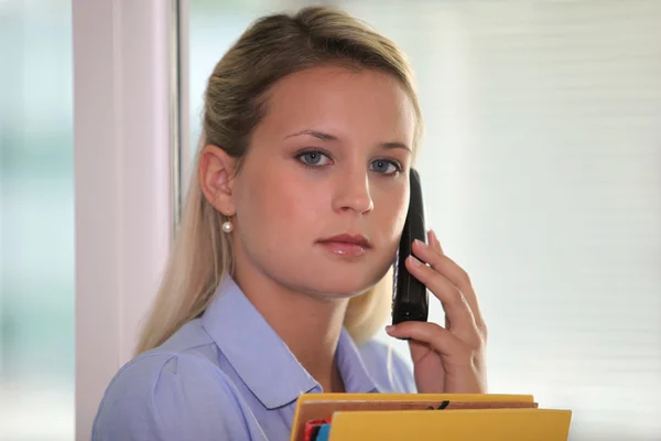 Serious young woman on the phone — Stock Photo, Image