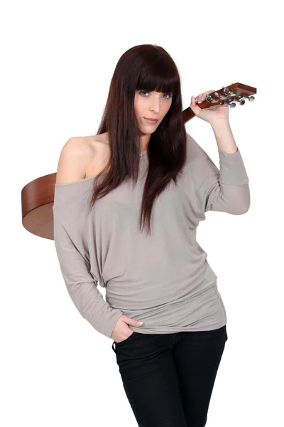 Woman holding an acoustic guitar Stock Picture