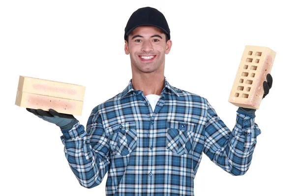 Mason holding a brick in either hand — Stock Photo, Image