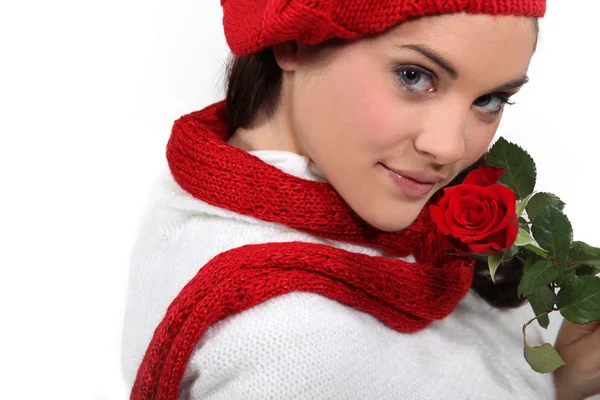 Brunette holding rose to face — Stock Photo, Image