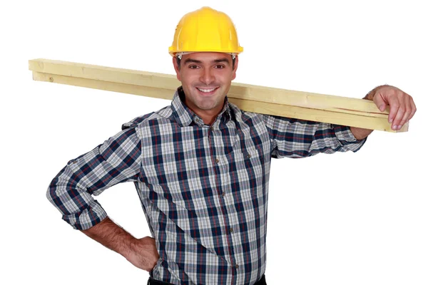 Carpinteiro alegre carregando madeira — Fotografia de Stock
