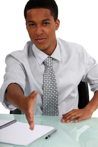 Black executive holding out hand to shake hands — Stock Photo, Image