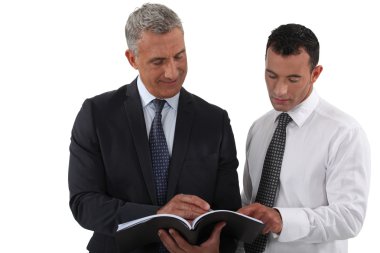 Two businessmen reading document clipart