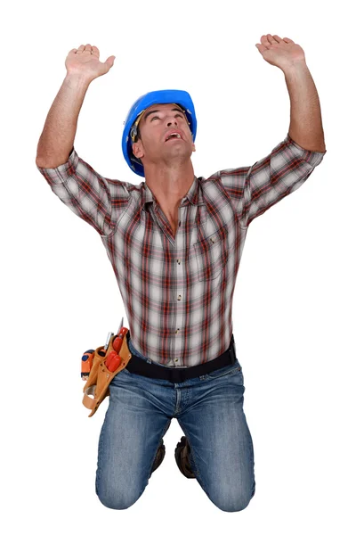 Builder holding up invisible object — Stock Photo, Image