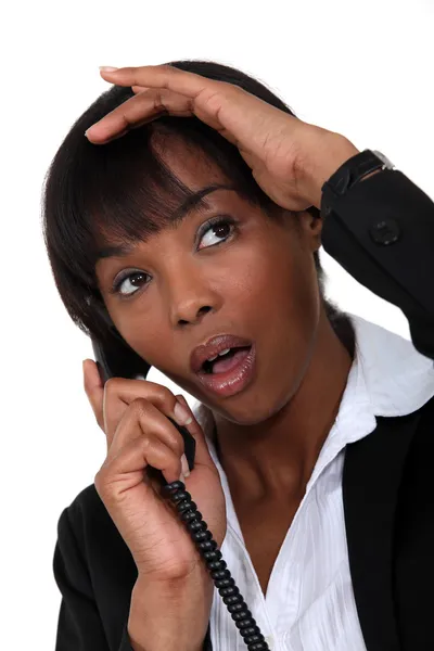 Businesswoman shocked by news she is receiving — Stock Photo, Image