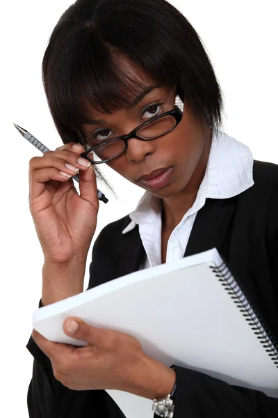 Businesswoman peering over her glasses — Stock Photo, Image