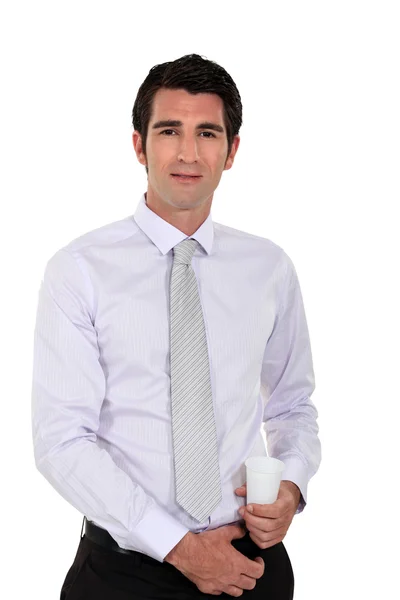 Businessman holding a plastic disposable cup — Stock Photo, Image