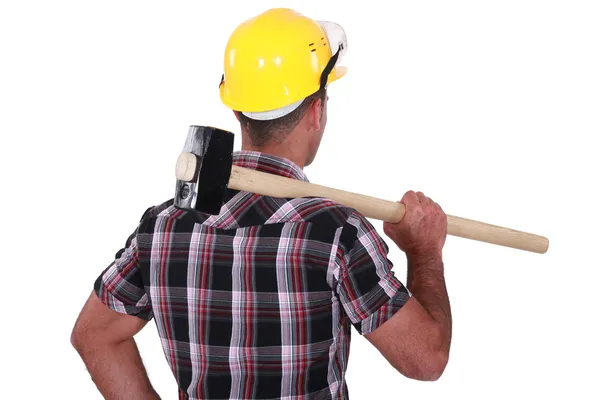 Man carrying sledge-hammer over shoulder — Stock Photo, Image