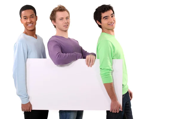 Three friends holding blank poster Royalty Free Stock Images