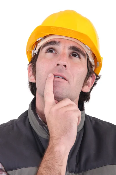 Tradesman deep in thought Stock Picture