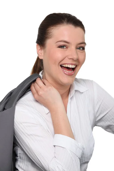 Laughing businesswoman with her jacket over her shoulder — Stock Photo, Image