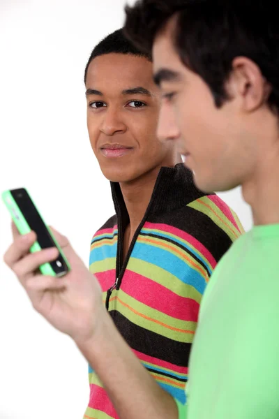 Deux jeunes hommes avec téléphone portable — Photo