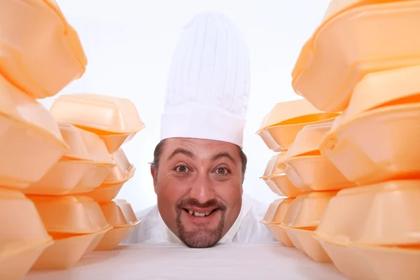 Chef surrounded by takeaway boxes — Stock Photo, Image